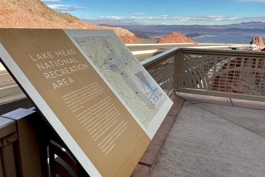 A signboard with information about Lake Mead National Recreation Area, a map, and a view of the surrounding landscape. 3