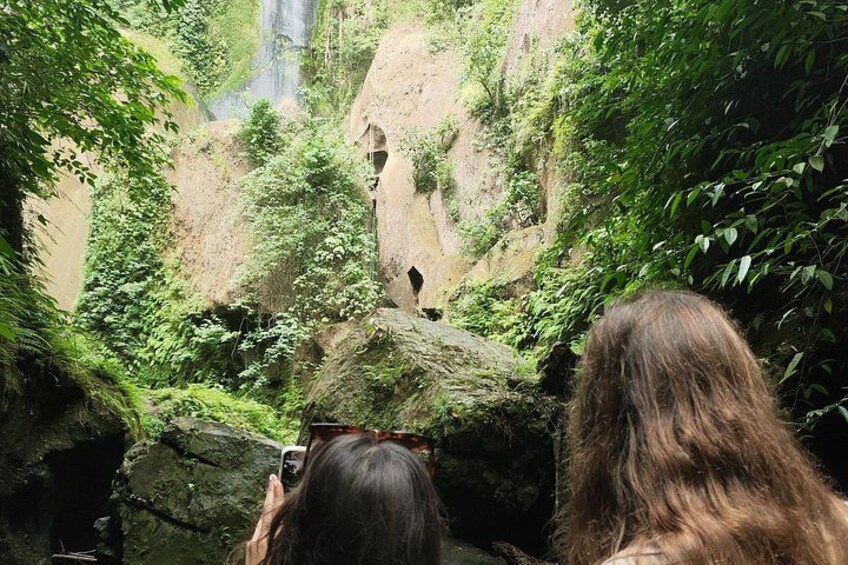 A waterfall, rocky terrain, and dense greenery. 5