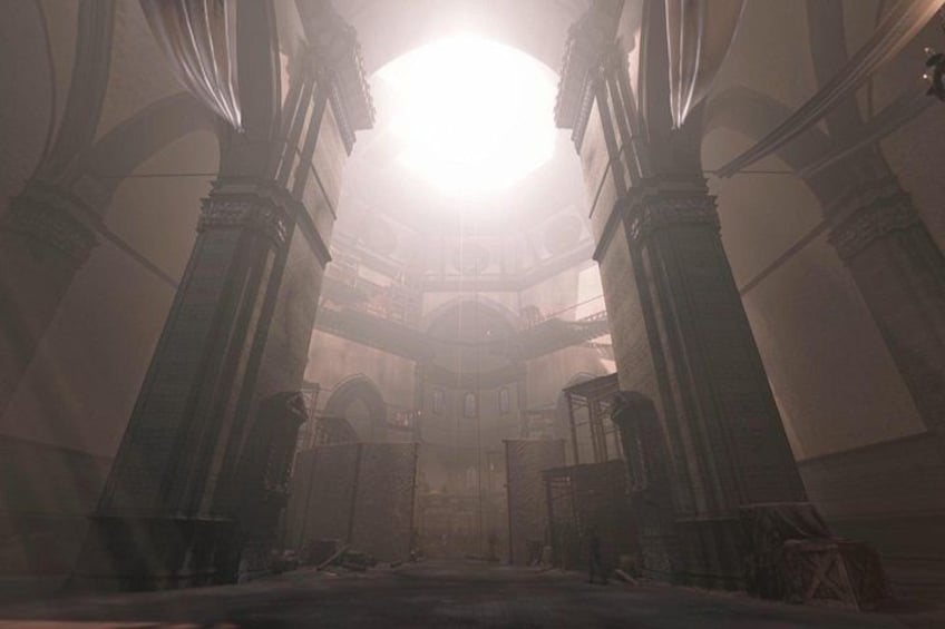 An interior with high ceilings, large columns, and a central open space. 2