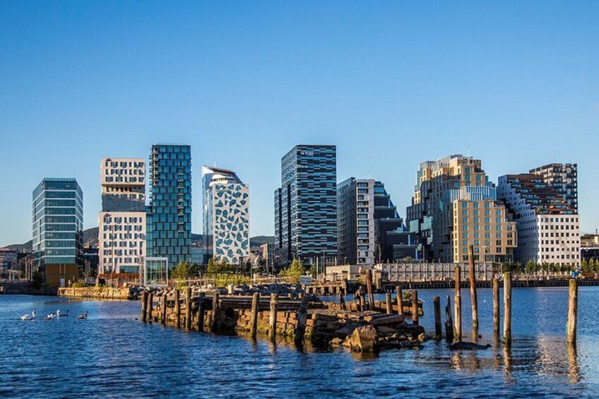 A waterfront cityscape with modern buildings and a dock. 4