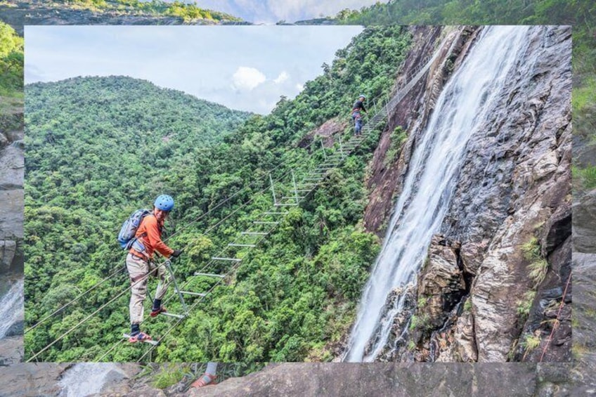 A hiker on a rope bridge over a lush forest, a waterfall, and a mountainous landscape. 1