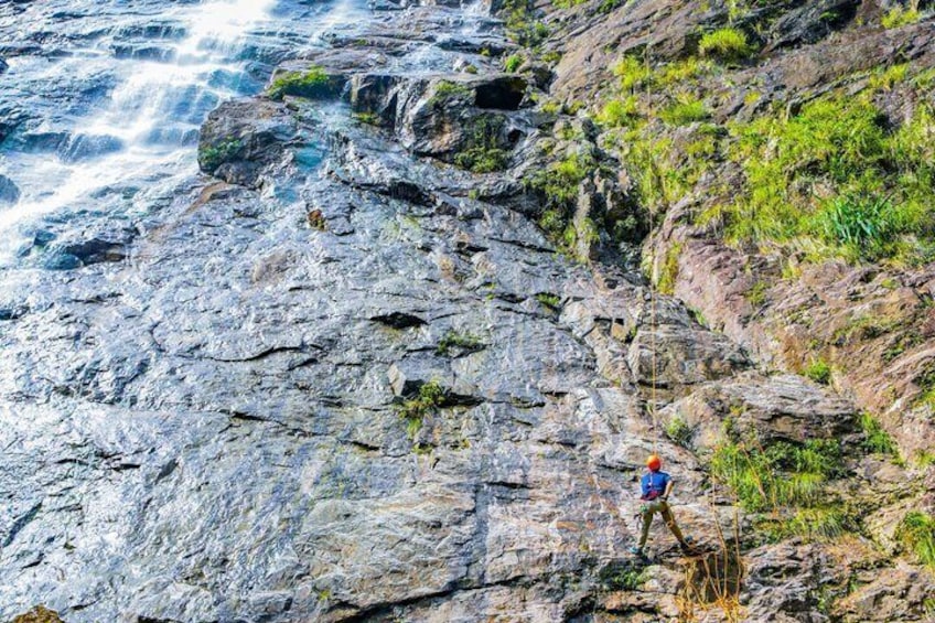 A rocky cliff with a person standing on it. 2