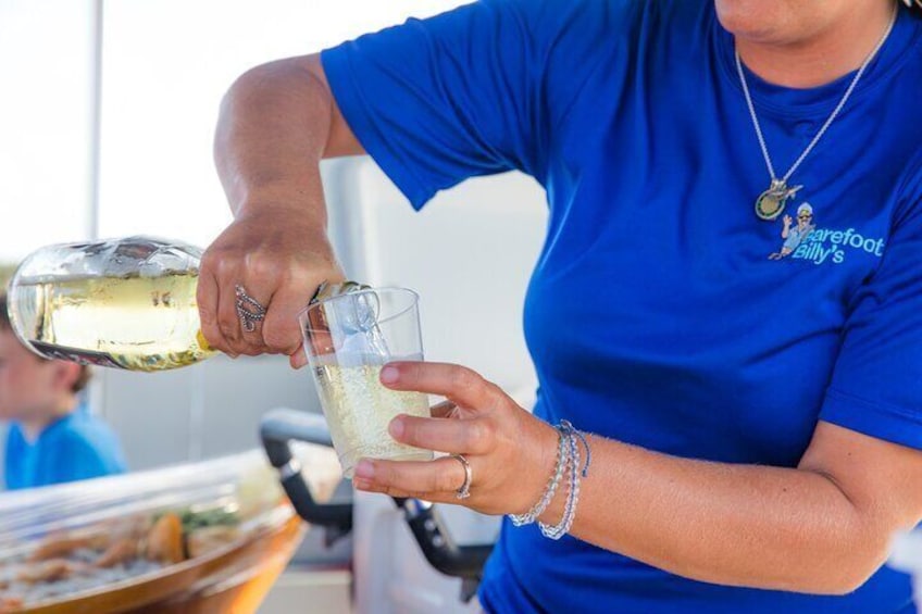 A person pouring a drink into a glass. 3