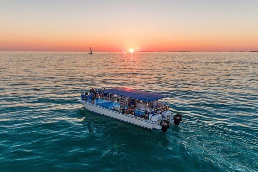 A boat on calm waters during sunset. 1