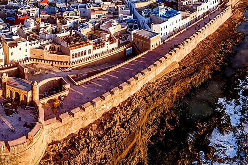 A fortified city with a prominent wall along a river. 4