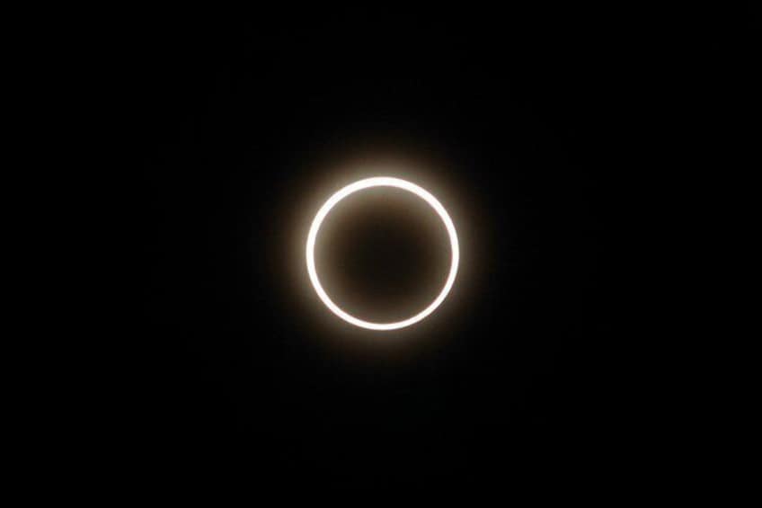 A ring-shaped object with a bright glow against a dark background. 1