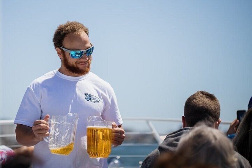A person holding two beer glasses. 3
