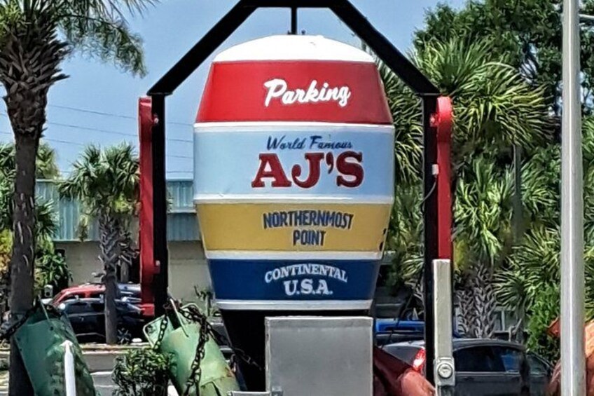 A parking meter with the text 'Parking World Famous A.J.'s Northernmost Point Continental U.S.A.' 4