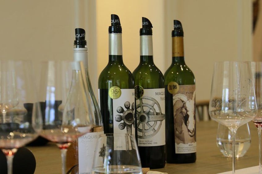 Wine bottles and glasses on a table. 1