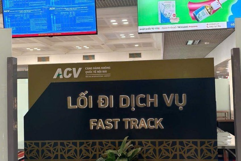 A sign with 'ACV' and 'FAST TRACK' written on it. 3
