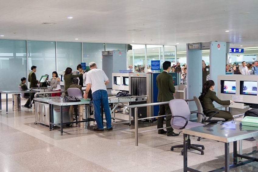 A busy airport check-in area with multiple desks and passengers. 1