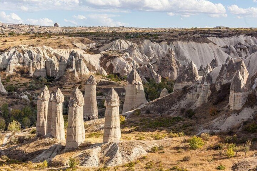 A landscape with prominent hoodoos and a distant hill. 3