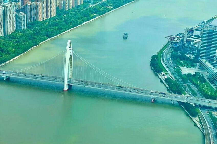 A large white bridge spanning a river, surrounded by urban buildings and greenery. 5