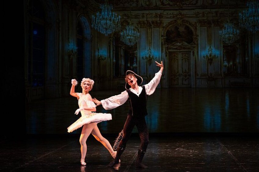 A ballet performance in a grand hall with ornate architecture and chandeliers. 3