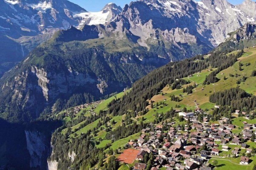 A mountainous landscape with a village nestled in the valley. 4