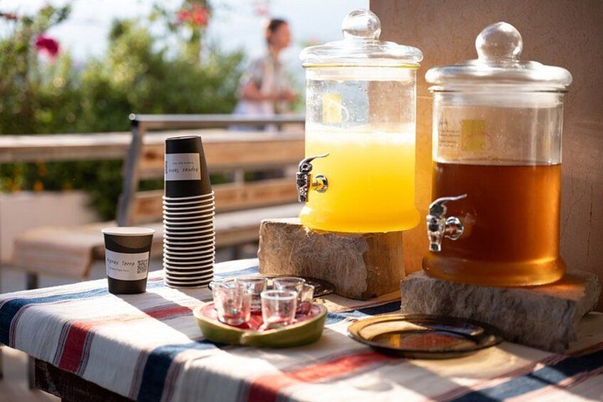 A table with a coffee maker, a glass of orange juice, and a glass of beer. 5