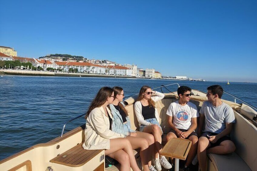 Un gruppo di persone su una barca, con uno skyline urbano sullo sfondo. 2