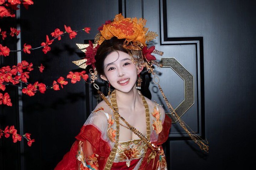 A person in traditional attire with a headdress and jewelry. 4