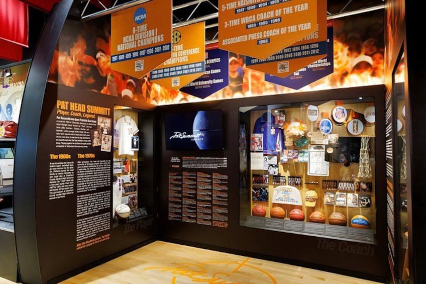 A sports memorabilia display with awards and a basketball court. 2
