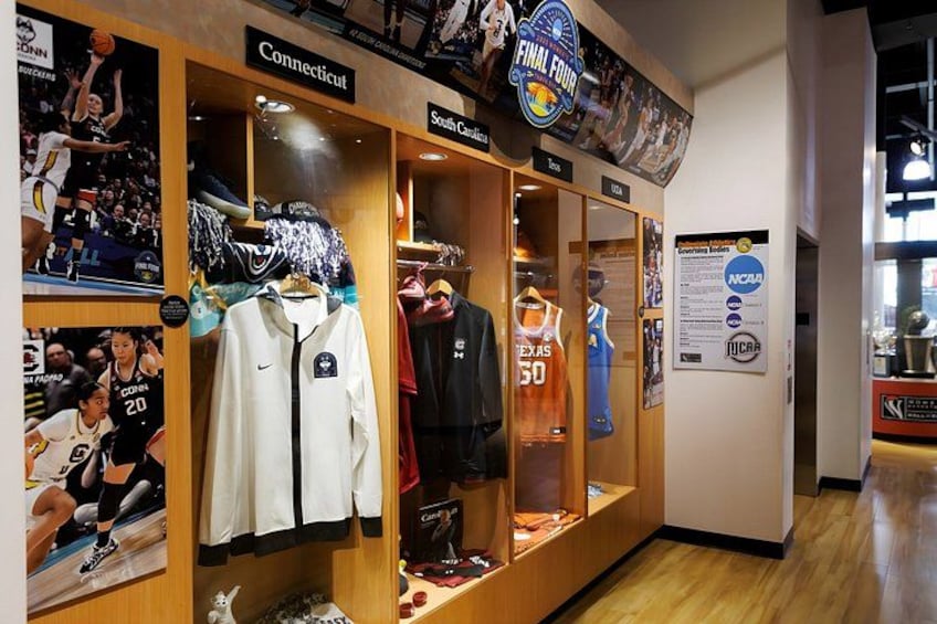 A sports memorabilia display with jerseys and a basketball hoop. 3