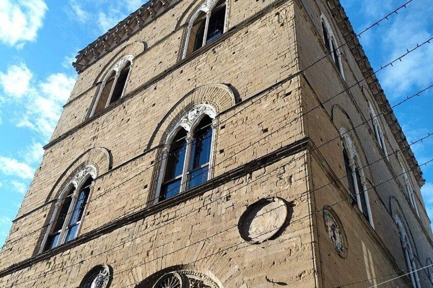 A historic building with arched windows and circular doorways. 3