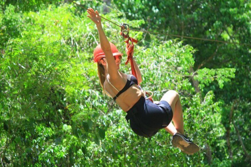 A person zip-lining through a forest. 5