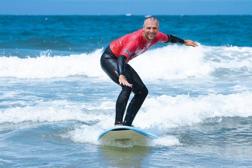 A person surfing on a wave in the ocean. 3