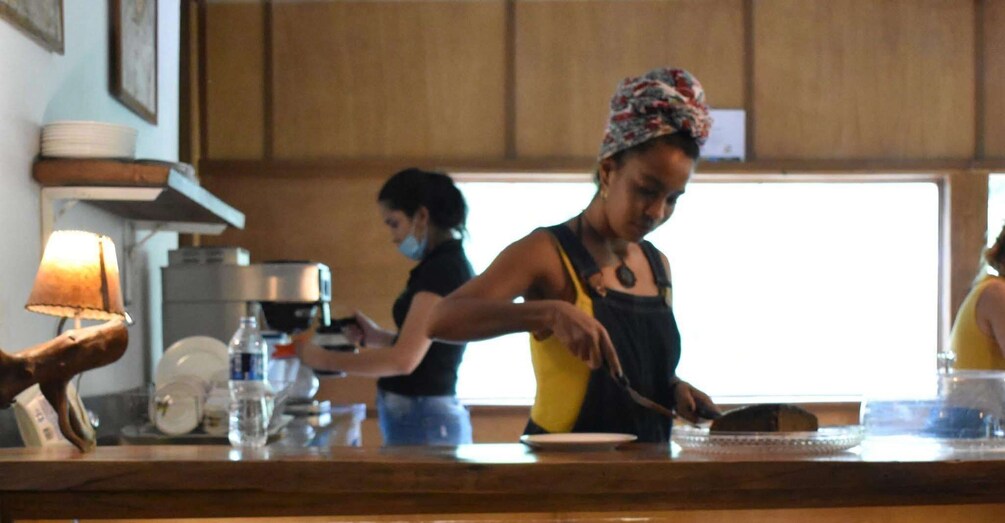 A kitchen with two people preparing food. 5