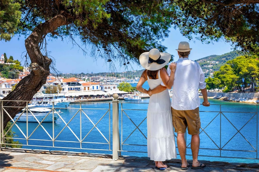 A couple overlooking a coastal town with boats and buildings. 4