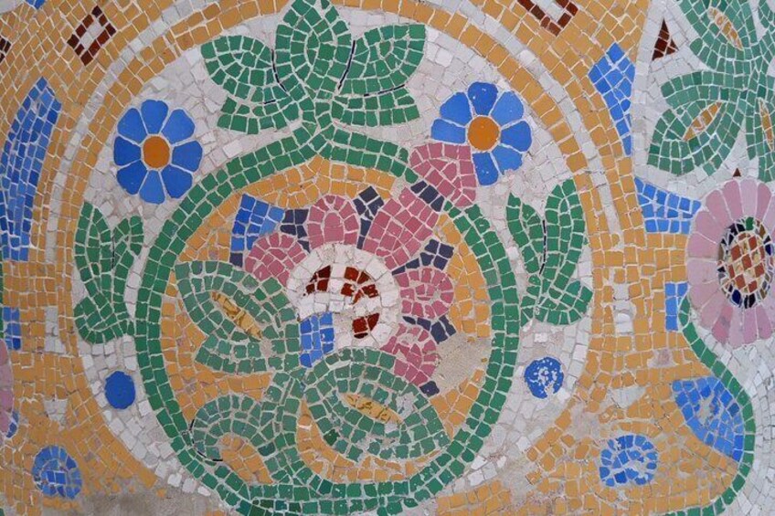 A mosaic with floral patterns and circular designs. 1