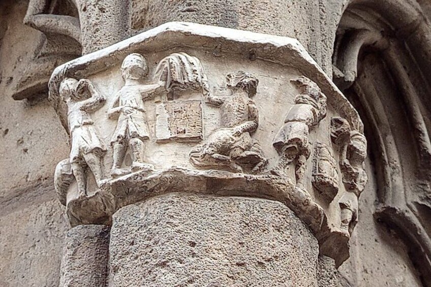 A stone carving with figures of people and animals on a column. 2