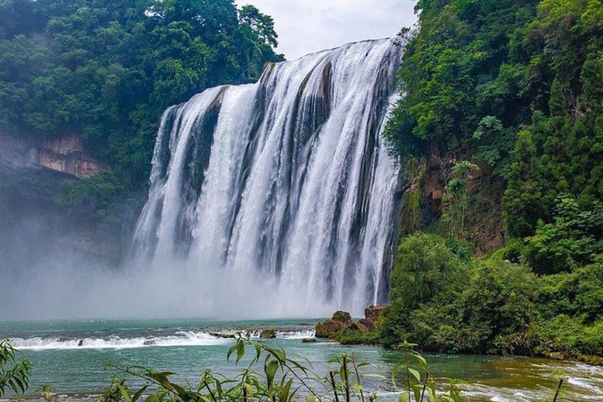 A large waterfall surrounded by lush greenery. 2