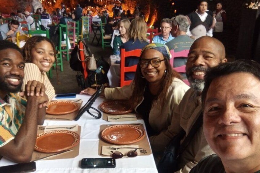 A group of people seated at a table with plates and cutlery. 4