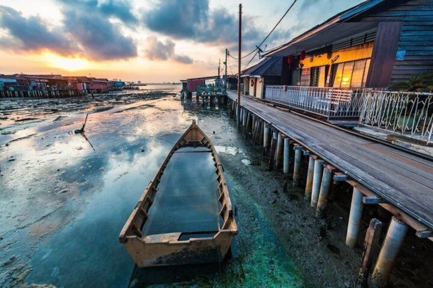 A wooden boat on a muddy shore, a wooden pier, and a building with a balcony. 2