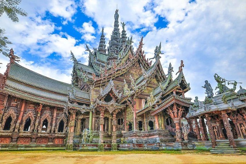 A traditional Thai temple with ornate architecture, including multiple tiers and intricate carvings. 2