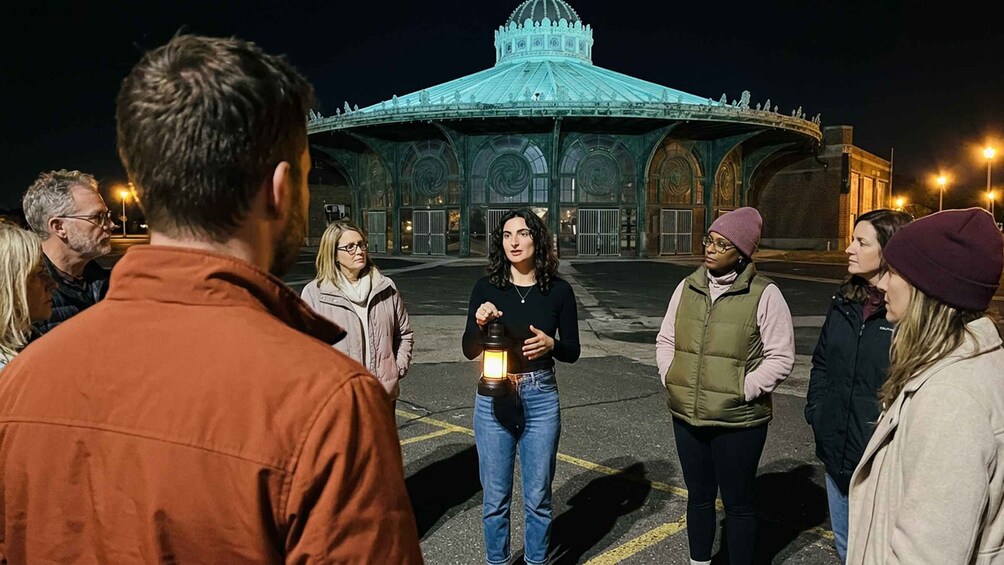 A group of people standing in a parking lot with a large, ornate building in the background. 4