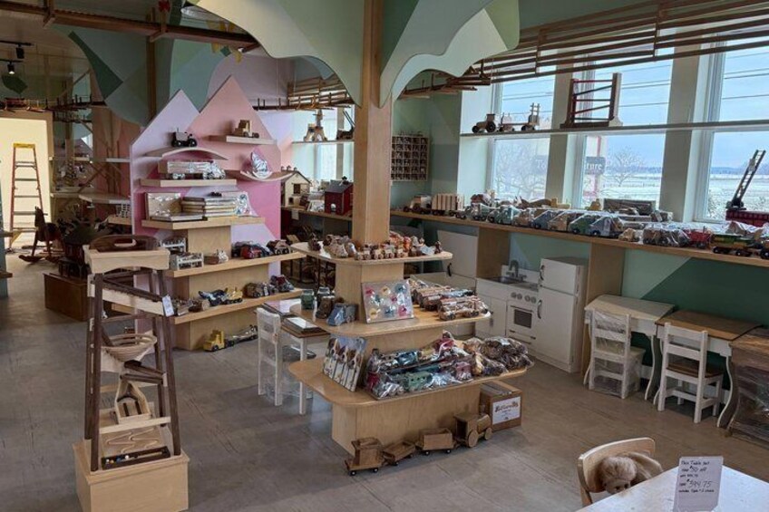 A craft store with wooden shelves, a ladder, and various crafting materials. 4