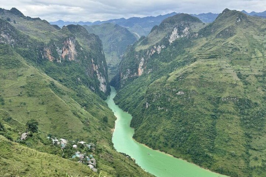 A river winding through a mountainous valley with lush greenery. 2