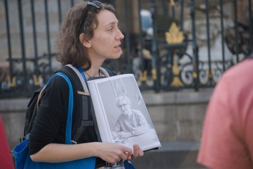 A person holding a framed picture and a water bottle. 3