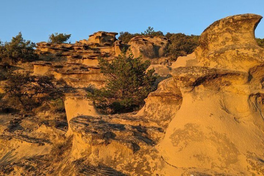 A desert landscape with prominent sandstone formations and sparse vegetation. 2