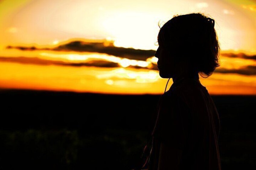 A silhouette of a person against a sunset. 2