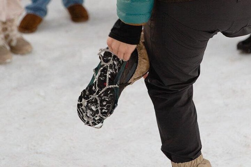 A person holding a snow-covered shoe. 5
