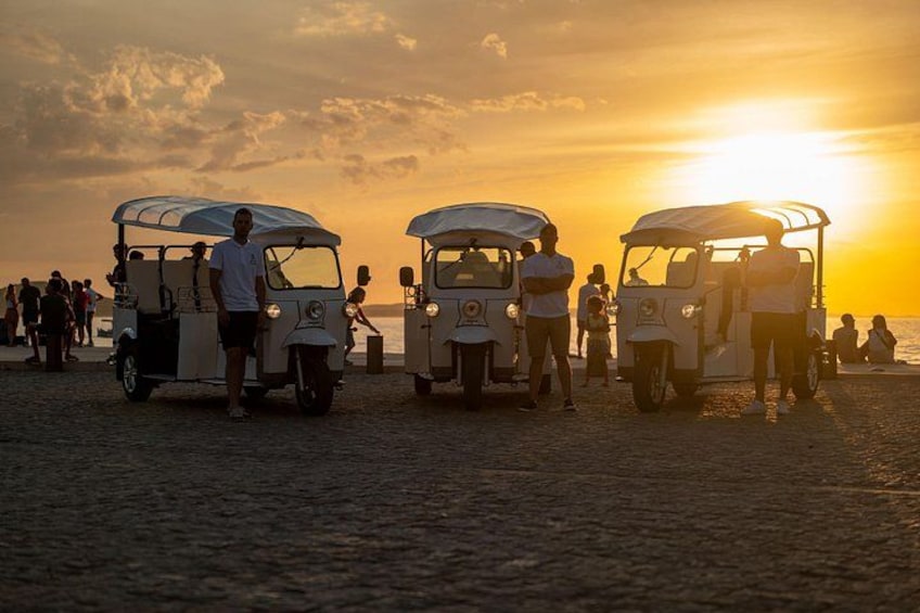 Vintage auto's staan op het strand bij zonsondergang. 3
