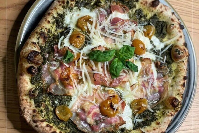 Pizza con formaggio, pomodori, basilico e prosciutto su un vassoio di metallo. 4