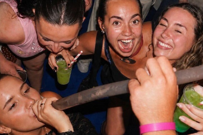A group of people gathered around a table with drinks. 5