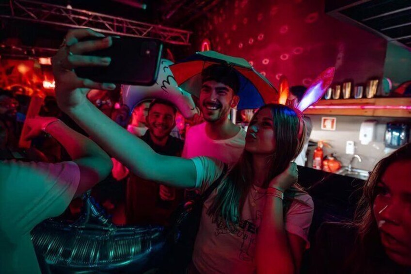 A crowded indoor event with people taking photos. 4