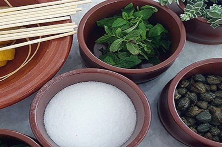 Various bowls containing salt, herbs, and peppercorns. 4