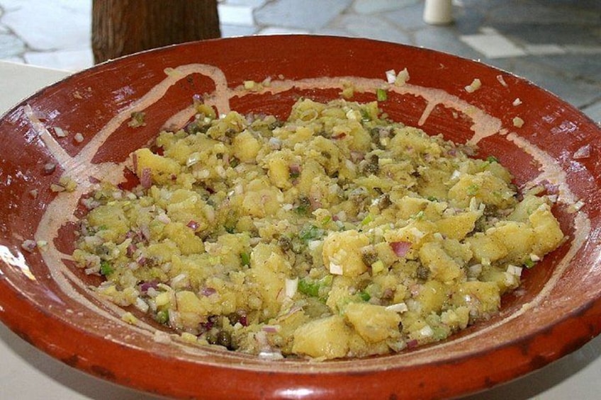 A red ceramic dish with a food mixture. 3