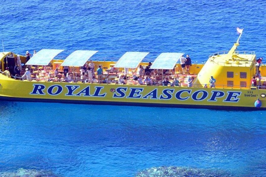 A yellow boat named 'ROYAL SEASCOPE' with people on board and a flag. 5