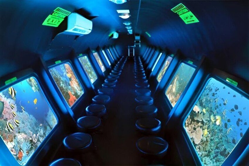 A tunnel with multiple aquarium windows, exit signs, and circular platforms. 3